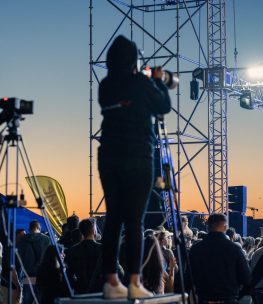 Cameramen Capturing Moments at a Live Event Cameramen on platforms capture the excitement of a live event at sunset.